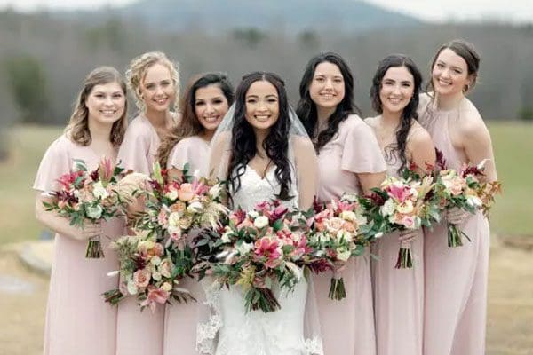 A bride and her bridesmaids posing for the camera.