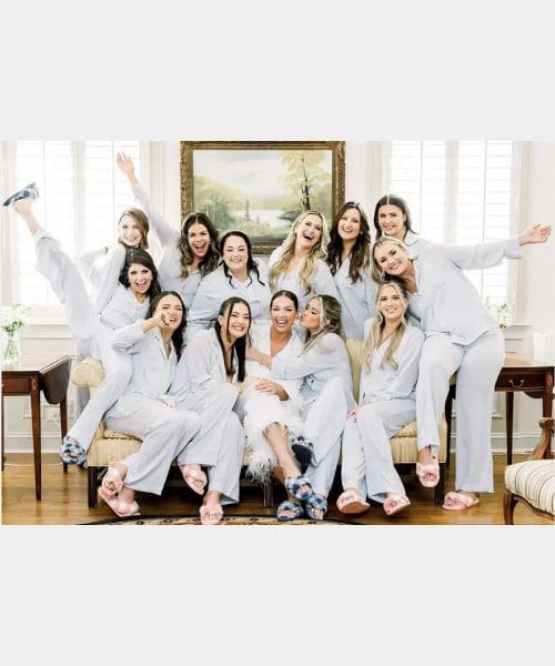 A group of women in white pajamas posing for the camera.