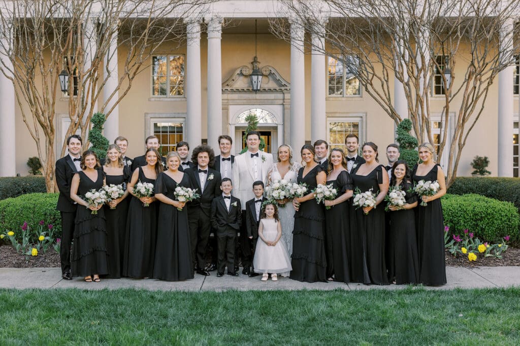 Wedding party in black dresses and suits.