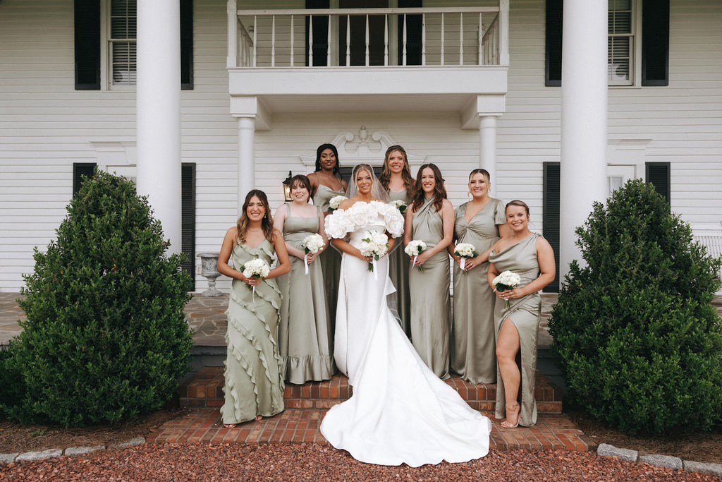 Bride and bridesmaids in green dresses.